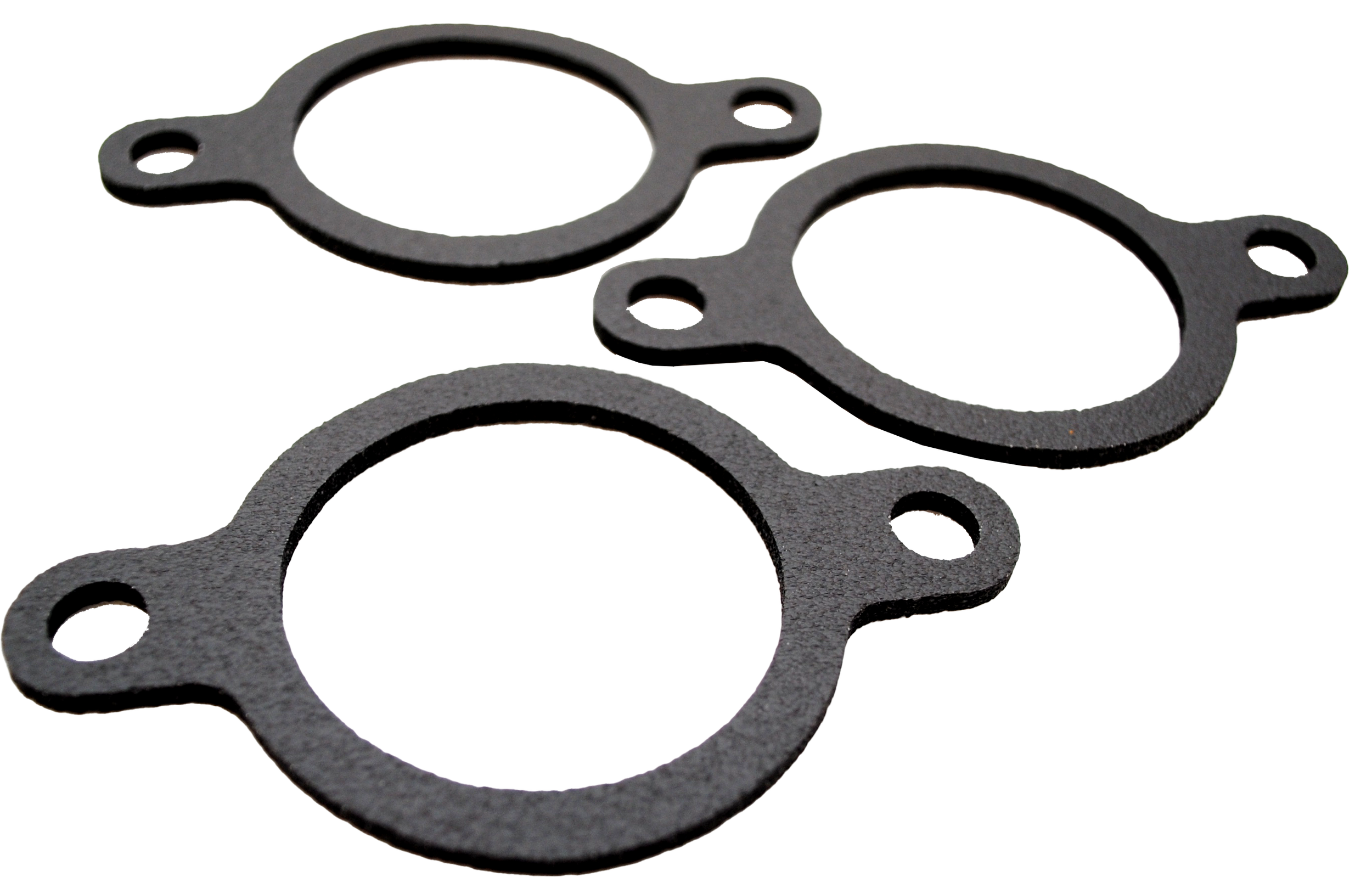 Three round black gaskets with two tabs and holes each